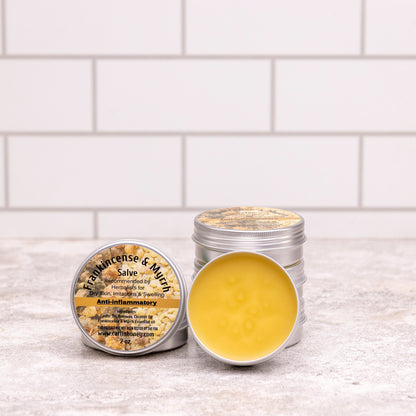 Two metal containers with a yellow substance on a white tiled surface
